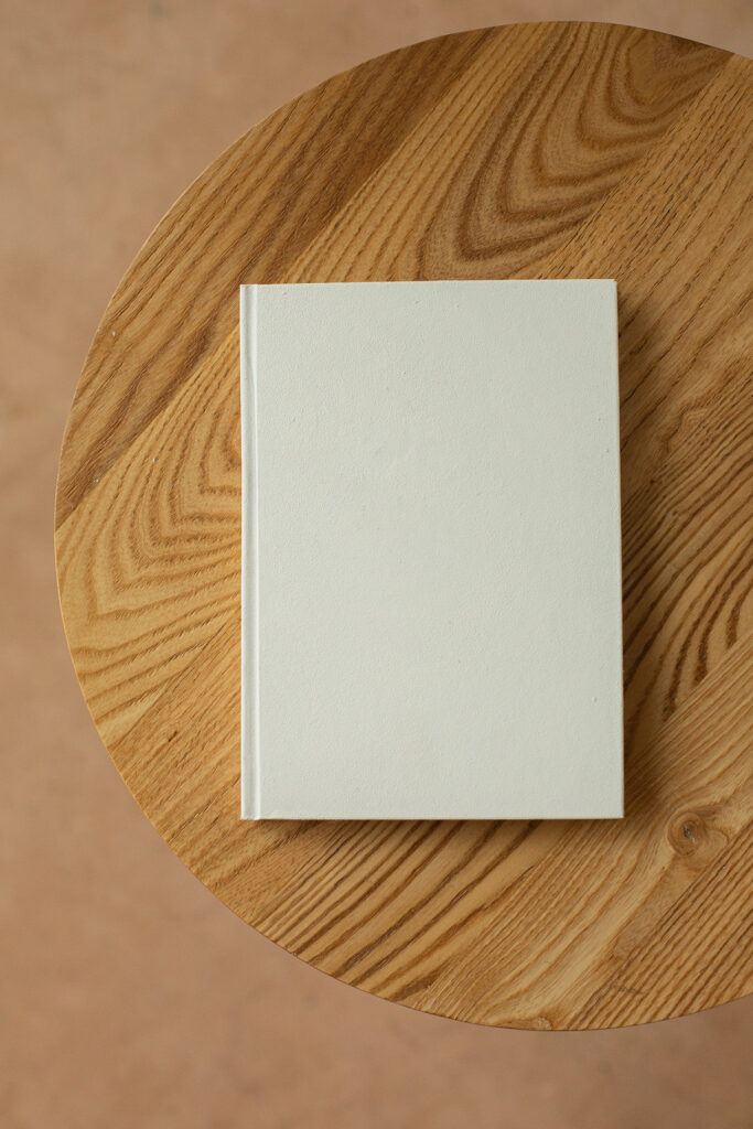 Book with white hard cover on table