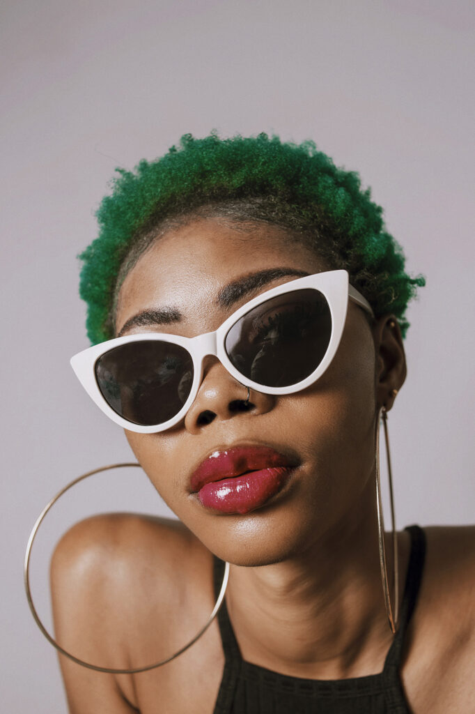 Woman with green hair and sunglasses